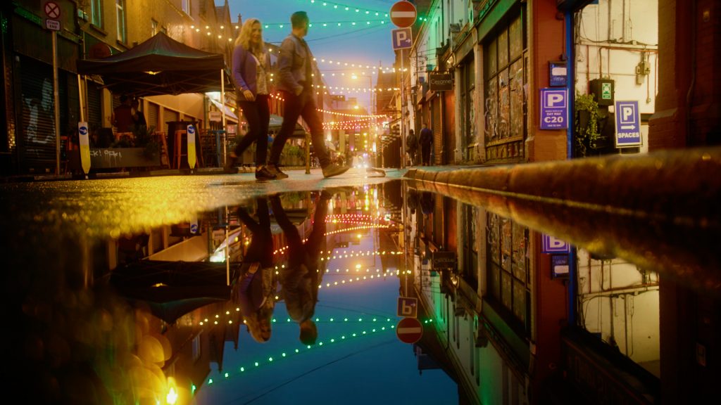 Reflection of city lights in a puddle on a street in Dublin, Ireland