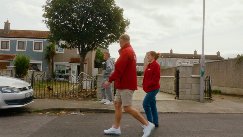 Outreach worker Daniel Jones speaking with community members on location