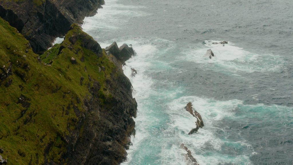 Powerful Atlantic waves smashing into rugged cliffs along the Irish coastline