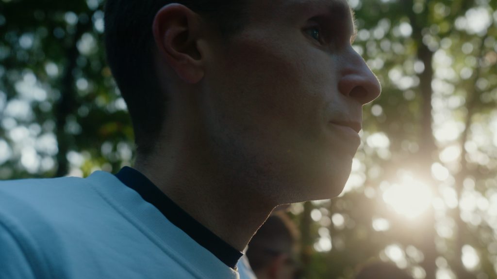 Backlit close-up of Stefan Orben, blind marathon runner, with sunlight filtering through foliage at Berlin Marathon