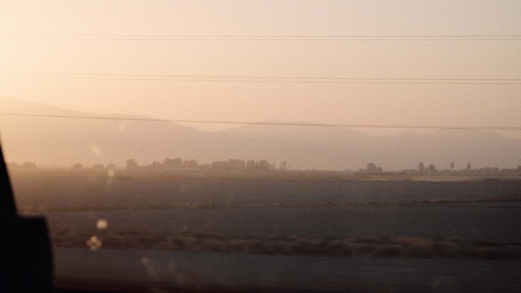 Sunrise casting warm light over the rugged landscape of Iran