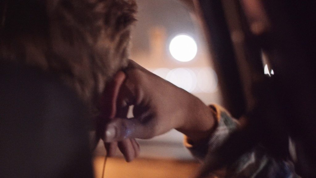 Over-the-shoulder shot of Tim Drobeck in the car during drive to the airport