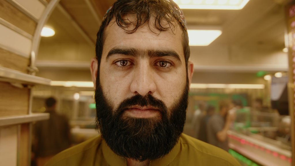 Wide portrait of cricket restaurant owner standing inside his venue