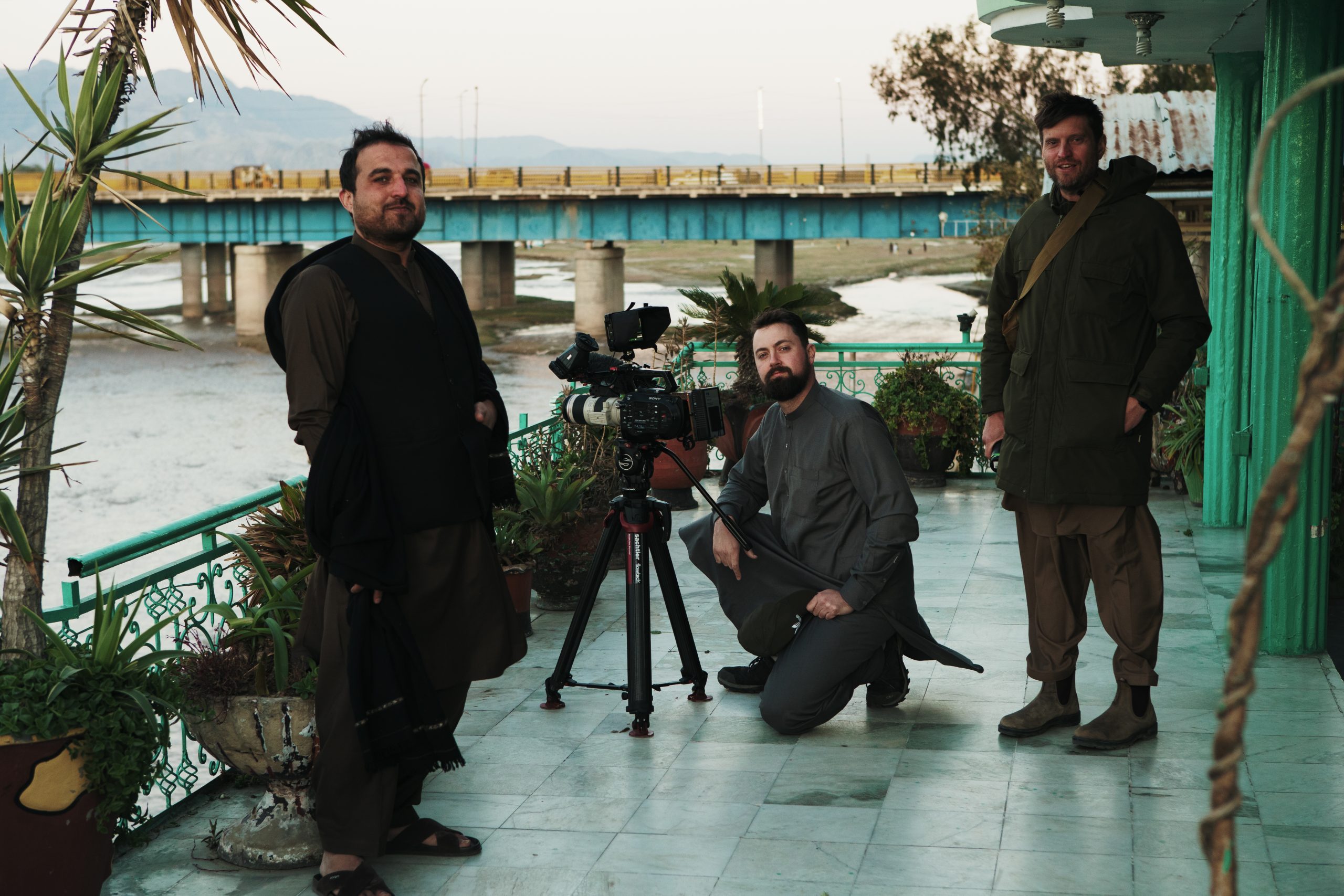 Killian Bayer, director Janek Speight, and their colleague shooting riverside footage in Afghanistan for a documentary project.