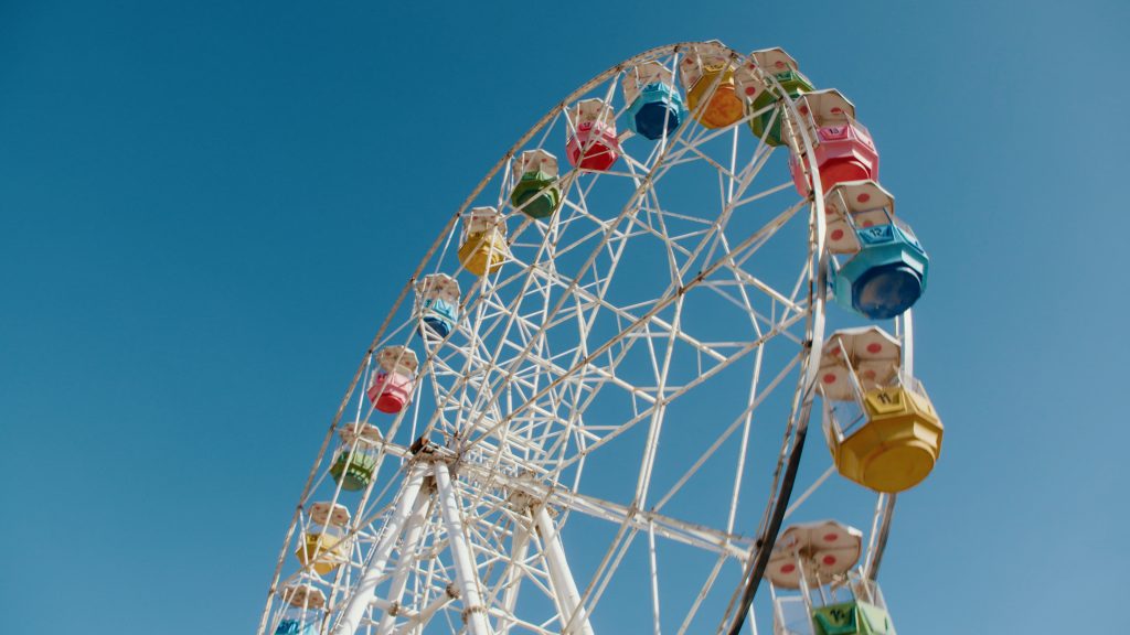 Low wide shot of Ferris wheel at amusement park in Kabul
