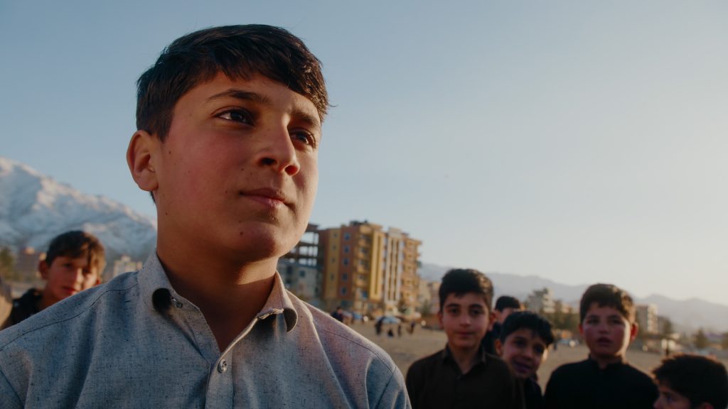 Medium close-up interview shot of young street cricket player