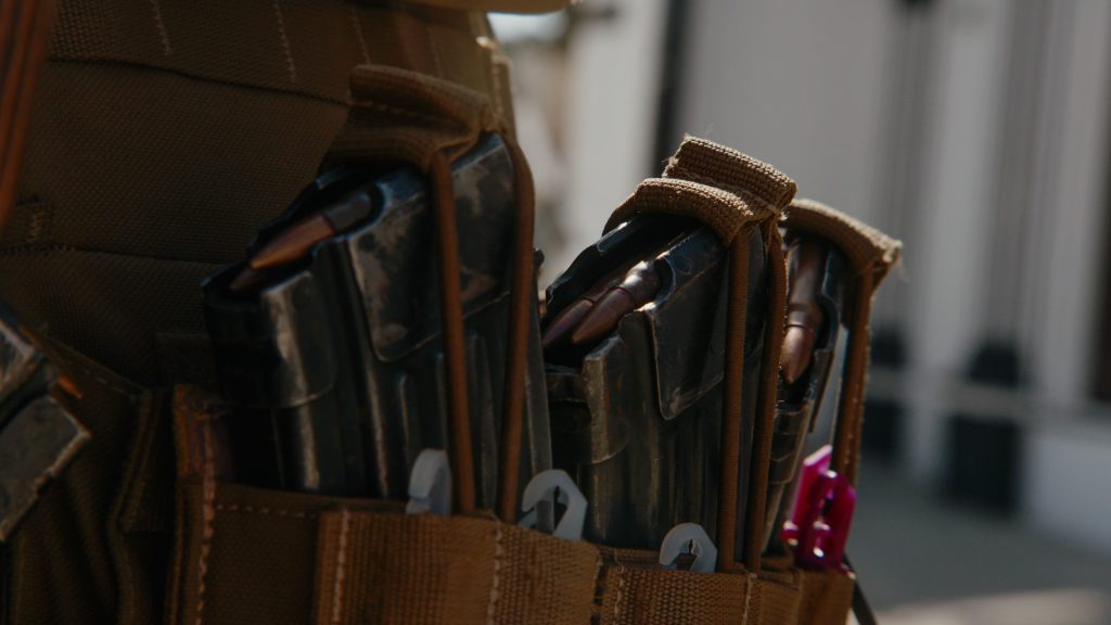 Close-up of Taliban GDI soldier in tactical gear with plate carrier and loaded magazines
