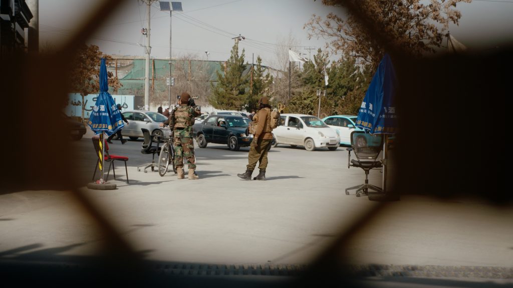 Taliban checkpoint filmed through a metal fence in the former Green Zone, Kabul