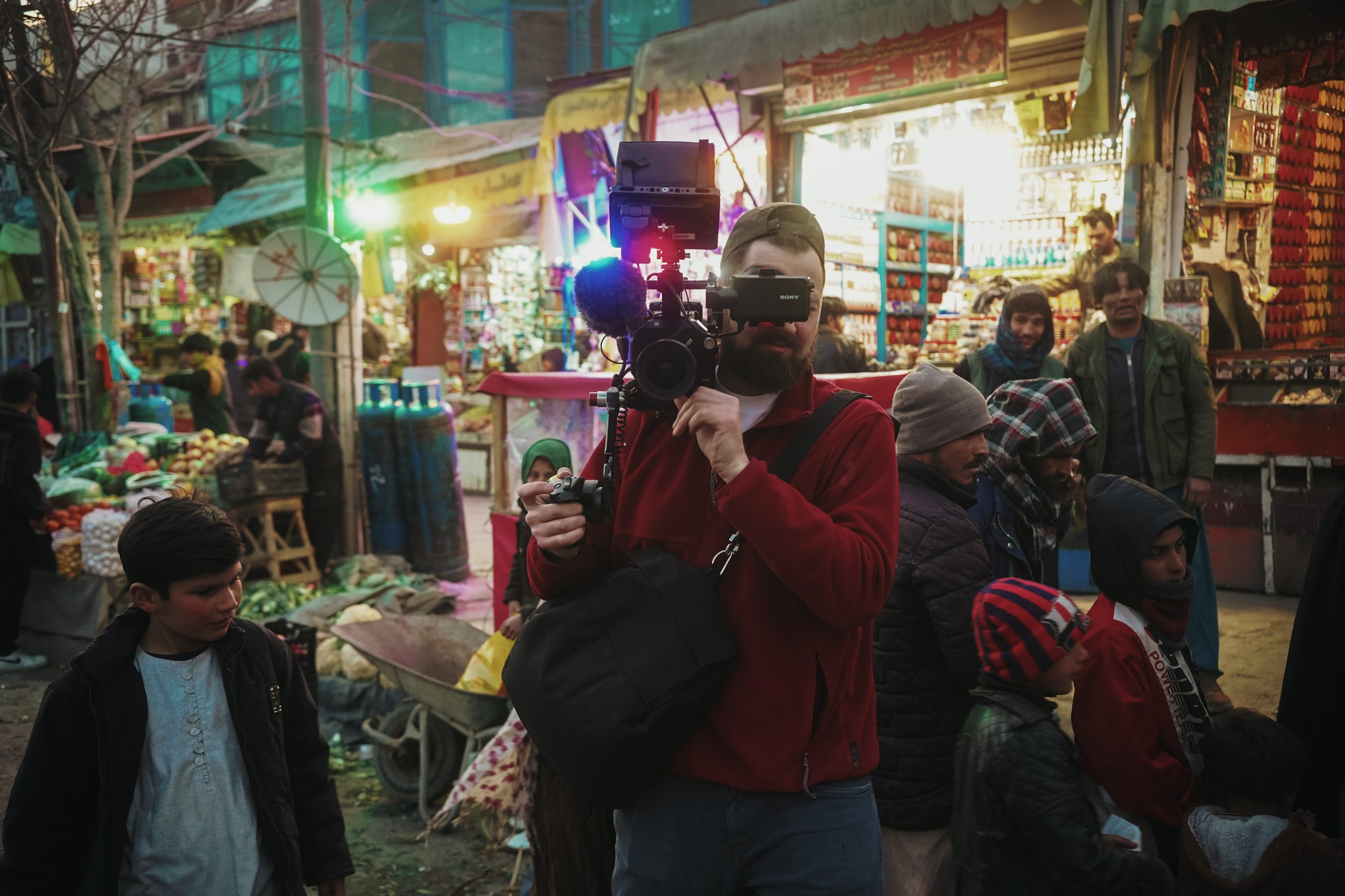 Killian Bayer, Berlin-based documentary director and director of photography, captured in a night-time Afghan market while looking through the viewfinder of his camera during a shoot.
