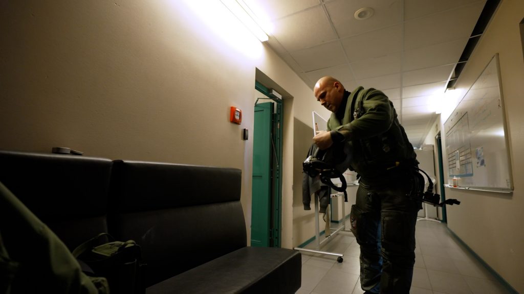 Lieutenant Connell Christoph Hachmeister racing to put on G-suit prior to scramble in Estonia