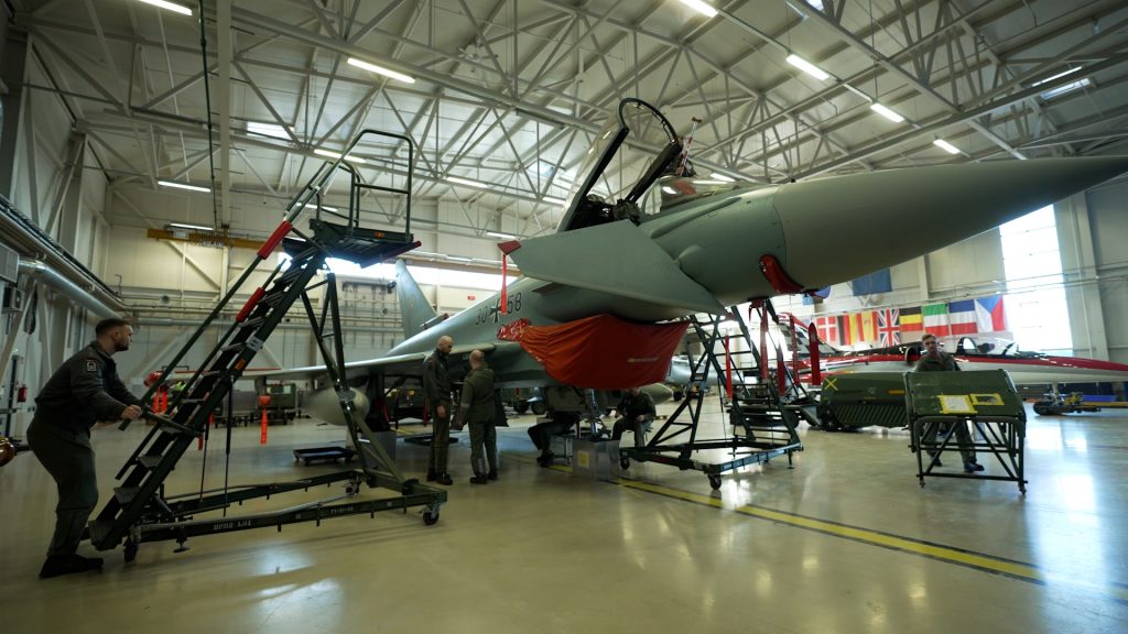 Ladder being rolled up to the cockpit of a Eurofighter jet under maintenance in a hanger in Tallinn, Estonia