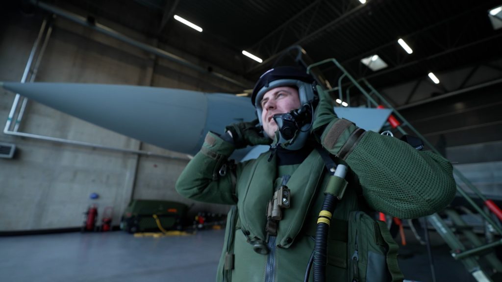 German NATO Eurofighter pilot putting on flight helmet prior to takeoff