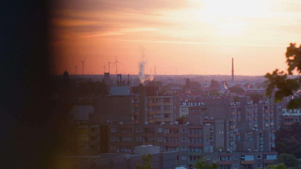 Telephoto shot of the sun rising over Plattenbauten in Berlin-Wedding