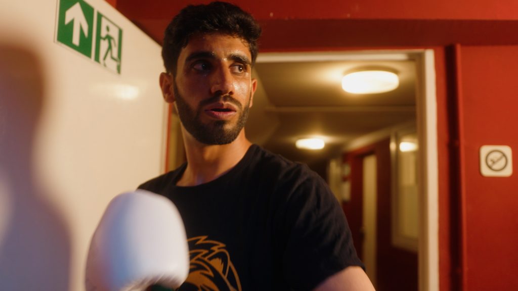 Afghan refugee boxer Shoaib Akhtar walking out of the locker room toward his fight